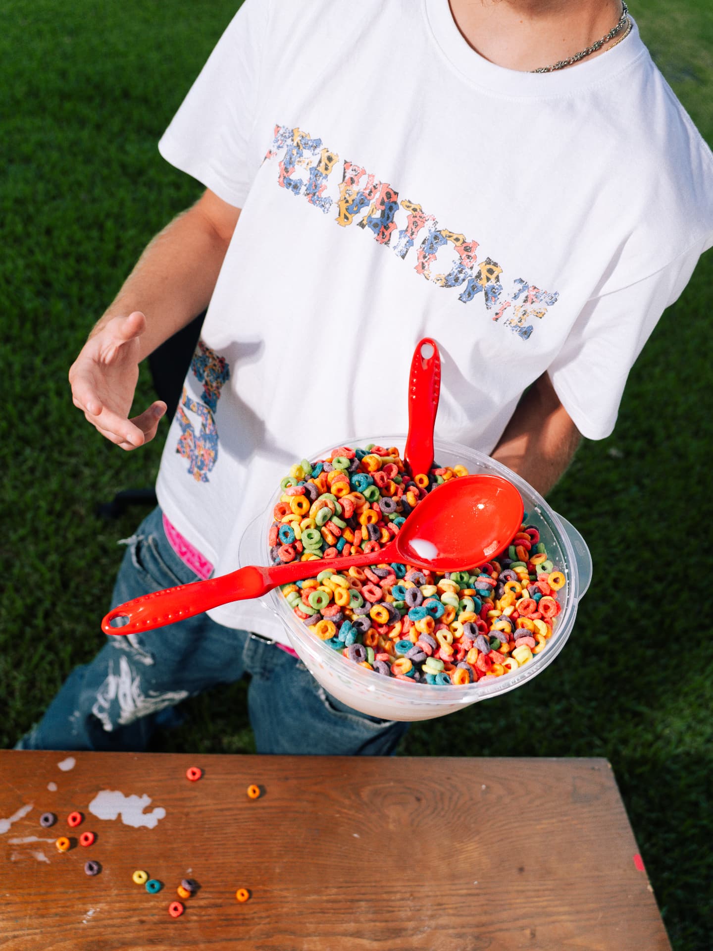 Model holding a bowl of fruit cereal wearing the VELVATONE tee