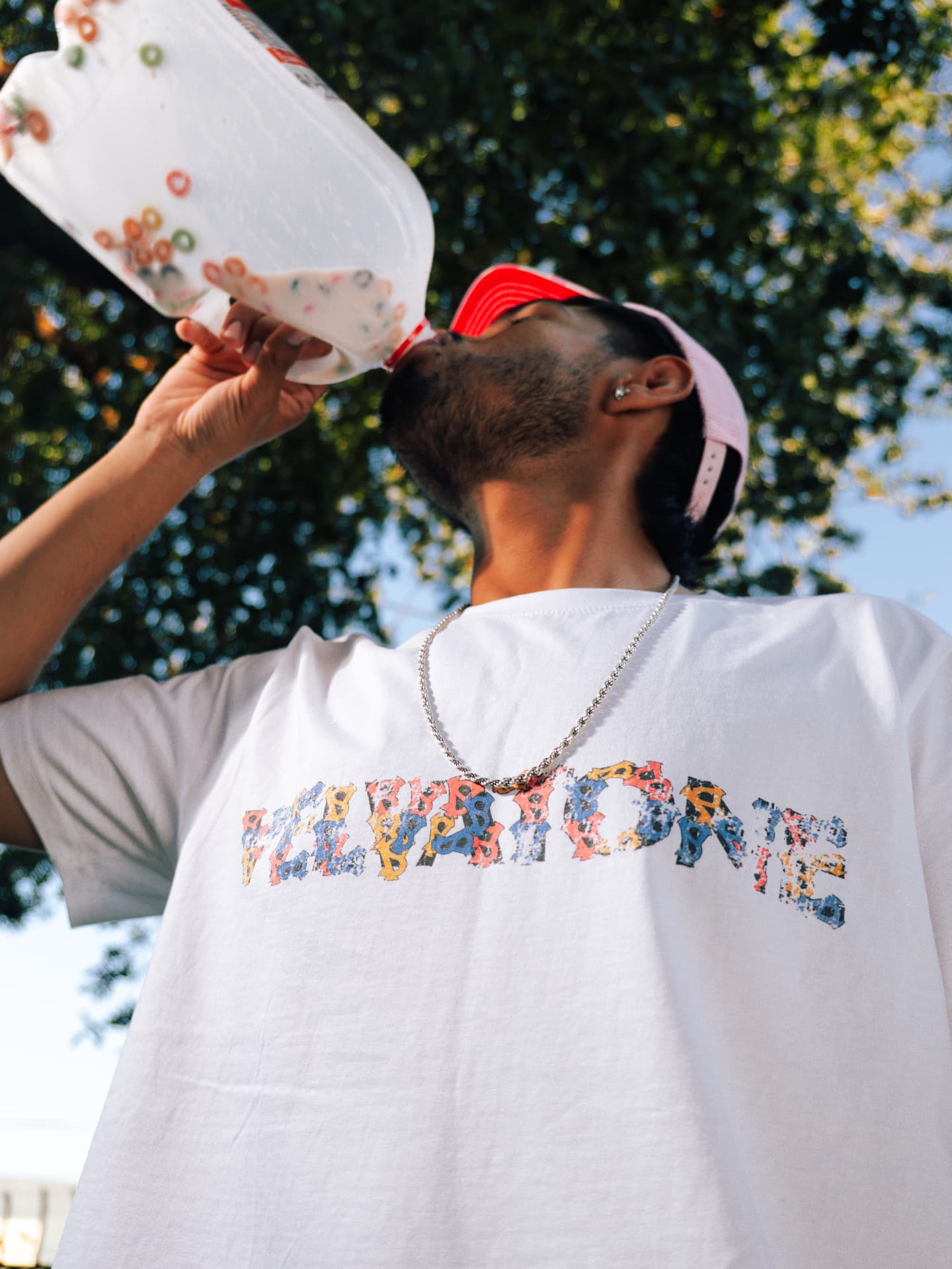 Model pouring milk while wearing the VELVATONE cereal tee